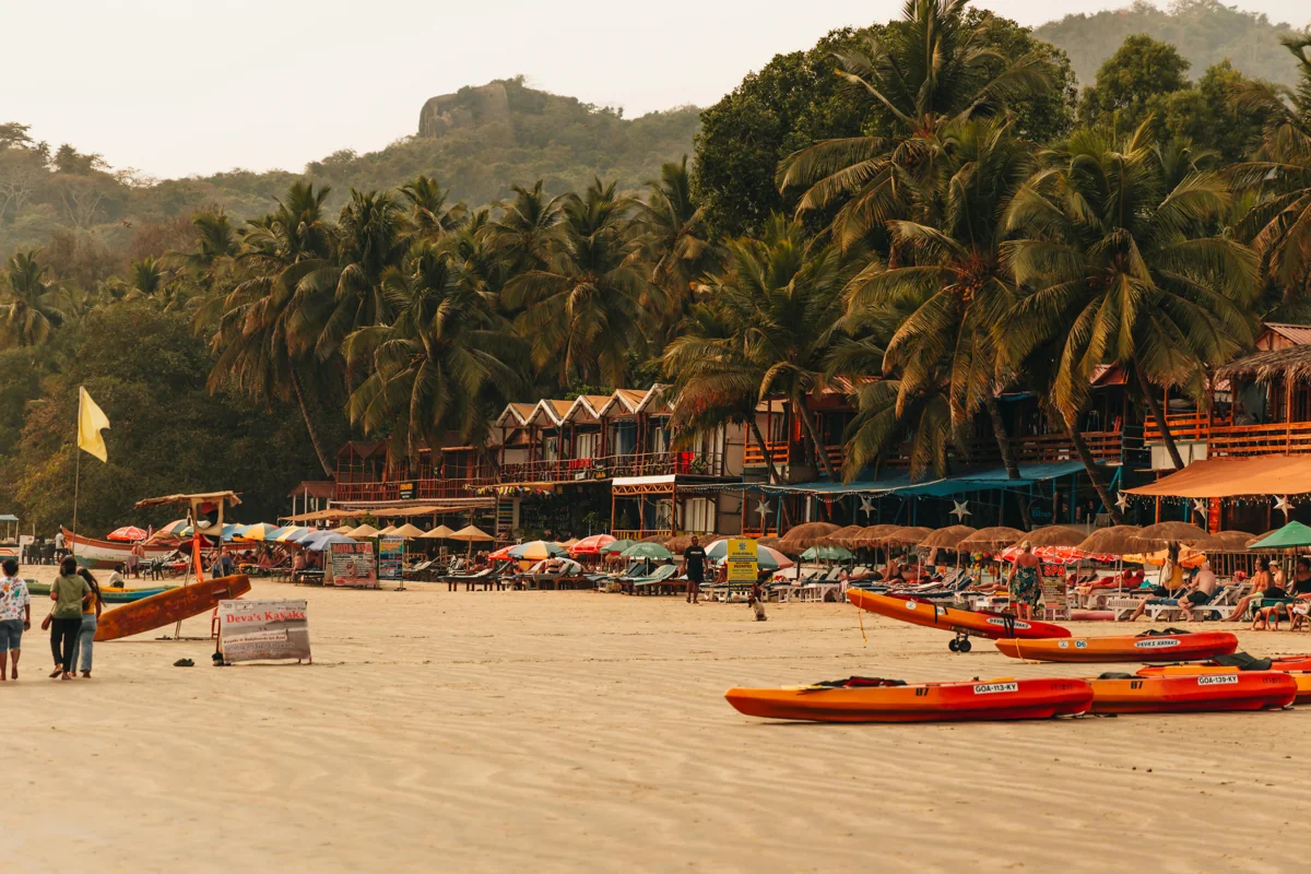 Goa beach with palm trees and colorful beach shacks by the Arabian Sea