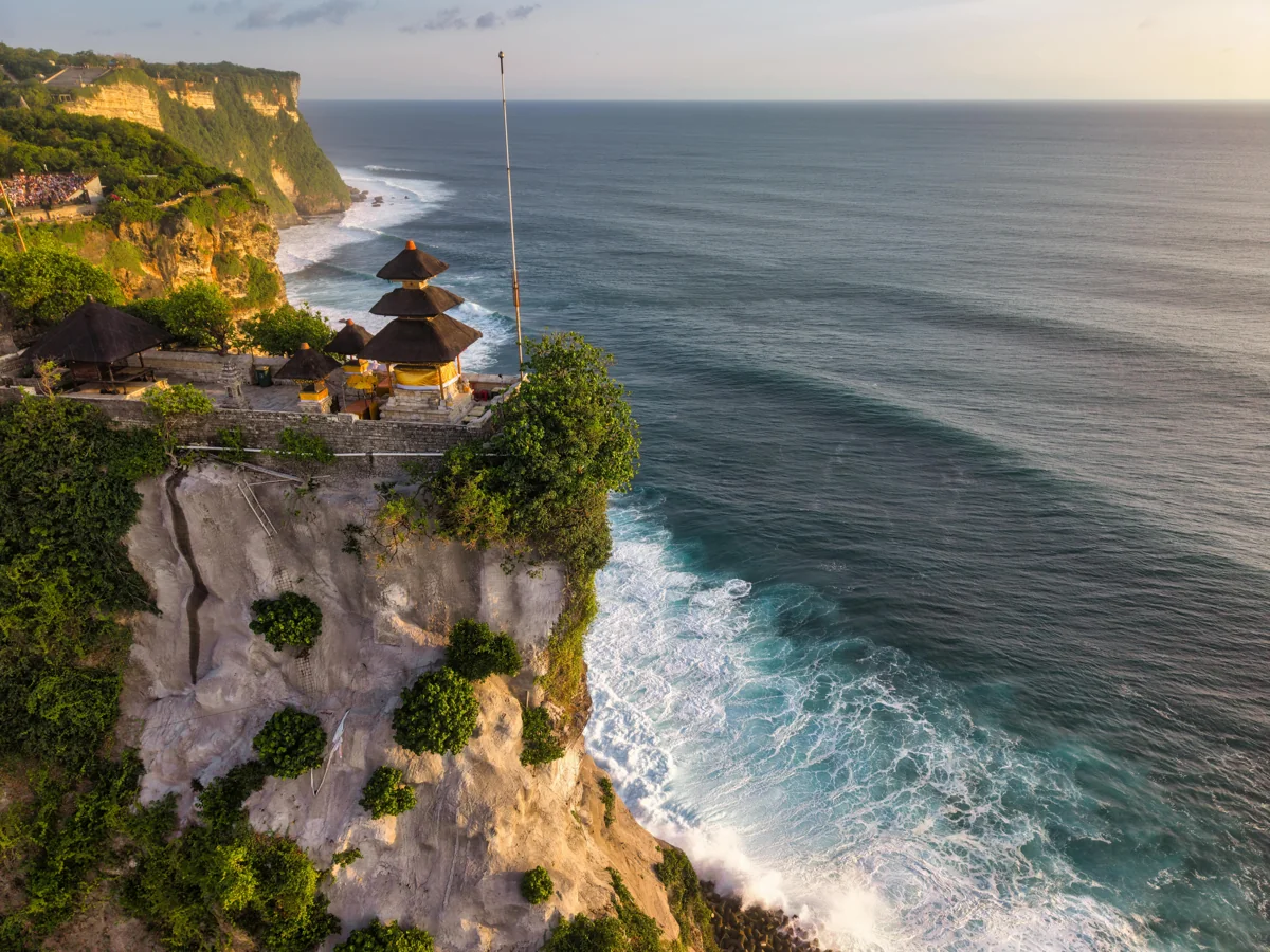 Bali tropical beach with turquoise water and traditional temple architecture