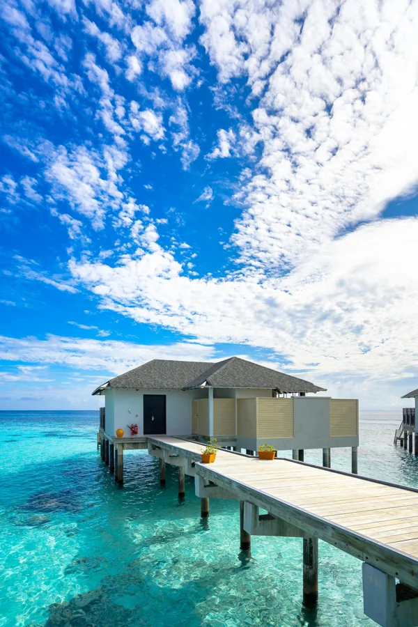 Maldives overwater bungalows with crystal clear turquoise ocean water